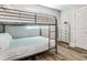 Bedroom with a metal bunk bed and dresser, ideal for guests at 156 175Th E Ave, Redington Shores, FL 33708