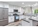 Modern kitchen with white cabinets and stainless steel appliances at 156 175Th E Ave, Redington Shores, FL 33708