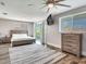 Large bedroom with king bed, private balcony, and ceiling fan at 156 175Th E Ave, Redington Shores, FL 33708
