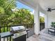 Private balcony with a grill and outdoor seating, perfect for relaxing at 156 175Th E Ave, Redington Shores, FL 33708