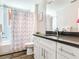 Clean bathroom with single vanity and tub shower combo at 156 175Th E Ave, Redington Shores, FL 33708