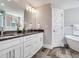 Elegant bathroom with double vanity, a soaking tub, and modern fixtures at 156 175Th E Ave, Redington Shores, FL 33708