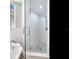 Modern walk-in shower with pebble floor and glass enclosure at 156 175Th E Ave, Redington Shores, FL 33708