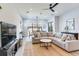 Open living room showcasing a large sectional sofa, a coffee table, and a large TV at 160 174Th Terrace E Dr # A, Redington Shores, FL 33708