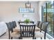 Elegant dining room with large windows and a wood table at 160 174Th Terrace E Dr # A, Redington Shores, FL 33708
