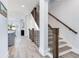Modern staircase with dark wood handrail and metal balusters at 160 174Th Terrace E Dr # A, Redington Shores, FL 33708
