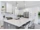 Modern kitchen with large island, white cabinets, and quartz countertops at 160 174Th Terrace E Dr # A, Redington Shores, FL 33708