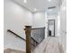 Upstairs hallway with wood railing and flooring at 160 174Th Terrace E Dr # A, Redington Shores, FL 33708