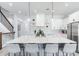 Modern kitchen with white cabinets, large island with seating, and stainless steel appliances at 160 174Th Terrace E Dr # A, Redington Shores, FL 33708