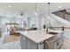 Open concept kitchen and living area with modern island and seating at 160 174Th Terrace E Dr # A, Redington Shores, FL 33708