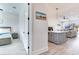 Guest bedroom with light wood furniture and access to living area at 160 174Th Terrace E Dr # A, Redington Shores, FL 33708