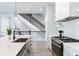 Open kitchen showcasing island, stainless steel appliances, and staircase view at 160 174Th Terrace E Dr # A, Redington Shores, FL 33708