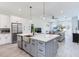 Open concept kitchen with island, stainless steel appliances, and view into adjacent living room at 160 174Th Terrace E Dr # A, Redington Shores, FL 33708