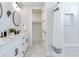 Modern bathroom with double vanity, marble floors, and shower at 160 174Th Terrace E Dr # A, Redington Shores, FL 33708