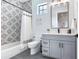 Modern bathroom with gray vanity, patterned tile, and bathtub at 160 174Th Terrace E Dr # A, Redington Shores, FL 33708