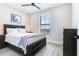 Bright bedroom with a comfortable bed, large window, and modern dresser at 160 174Th Terrace E Dr # A, Redington Shores, FL 33708