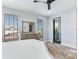 Spacious bedroom with king bed, dresser, and private balcony access at 160 174Th Terrace E Dr # A, Redington Shores, FL 33708