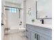 Bathroom with gray vanity, tub, and shower at 160 174Th Terrace E Dr # A, Redington Shores, FL 33708