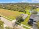 Aerial view showing home, landscape, and pond at 6226 Desert Peace Ave, Land O Lakes, FL 34639