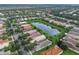 Aerial view showcases a well-maintained community with ponds and mature trees at 15911 Cobble Mill Dr, Wimauma, FL 33598