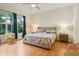 Well-lit bedroom with hardwood floors and a comfortable king-sized bed at 15911 Cobble Mill Dr, Wimauma, FL 33598