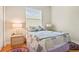Cozy bedroom with hardwood floors, a patterned quilt, and natural light at 15911 Cobble Mill Dr, Wimauma, FL 33598