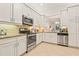Well-equipped kitchen featuring stainless steel appliances, granite countertops, and ample storage space at 15911 Cobble Mill Dr, Wimauma, FL 33598