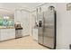 Spacious kitchen featuring stainless steel appliances, granite countertops, and ample white cabinetry at 15911 Cobble Mill Dr, Wimauma, FL 33598