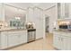 Kitchen with stainless steel appliances, granite countertops, white cabinets and modern tile flooring at 15911 Cobble Mill Dr, Wimauma, FL 33598
