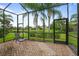Relaxing screened lanai with brick floor, overlooking the lush backyard and tranquil pond at 15911 Cobble Mill Dr, Wimauma, FL 33598