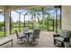 Relaxing screened patio with outdoor seating and a view of the lush backyard and pond at 15911 Cobble Mill Dr, Wimauma, FL 33598