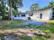 The backyard features a concrete patio and ample space for outdoor activities at 2145 68Th S Ave, St Petersburg, FL 33712