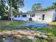 The backyard features a concrete patio and ample space for outdoor activities at 2145 68Th S Ave, St Petersburg, FL 33712