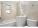 Bathroom with a bathtub, vanity, toilet and window at 2145 68Th S Ave, St Petersburg, FL 33712
