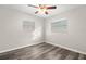 Well-lit bedroom with wood-look floors and two windows with blinds at 2145 68Th S Ave, St Petersburg, FL 33712
