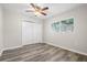 Bright bedroom with wood-look floors, ceiling fan, and double door closet at 2145 68Th S Ave, St Petersburg, FL 33712