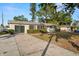Ranch-style home with driveway and landscaped yard at 2145 68Th S Ave, St Petersburg, FL 33712