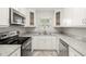 Modern kitchen, featuring white cabinets and granite countertops at 2145 68Th S Ave, St Petersburg, FL 33712