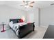 Bedroom featuring a black sleigh bed and ceiling fan at 8945 Magnolia Chase Cir, Tampa, FL 33647