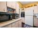Bright kitchen with white appliances and wood cabinets at 509 Langford Cir, Plant City, FL 33563