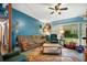 Spacious living room with a brown couch and access to backyard at 509 Langford Cir, Plant City, FL 33563