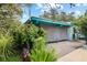 Teal house with carport and lush landscaping at 509 Langford Cir, Plant City, FL 33563