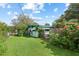 Large backyard with lush landscaping and wooden fence at 509 Langford Cir, Plant City, FL 33563