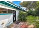 Home's side yard with patio and lush landscaping at 509 Langford Cir, Plant City, FL 33563