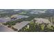 Aerial view showing home nestled in a wooded area near farmlands at 2804 Holloway Rd, Plant City, FL 33567