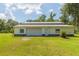 White barn-style workshop with roll-up garage door at 2804 Holloway Rd, Plant City, FL 33567