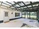 Screened porch with exterior door and view of backyard at 2804 Holloway Rd, Plant City, FL 33567