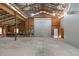 Unfinished workshop with roll-up door and high ceilings at 2804 Holloway Rd, Plant City, FL 33567
