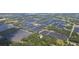 Aerial view of property situated amongst agricultural fields and trees at 2804 Holloway Rd, Plant City, FL 33567