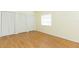 Simple bedroom with wood-look floors and multiple closets at 2804 Holloway Rd, Plant City, FL 33567
